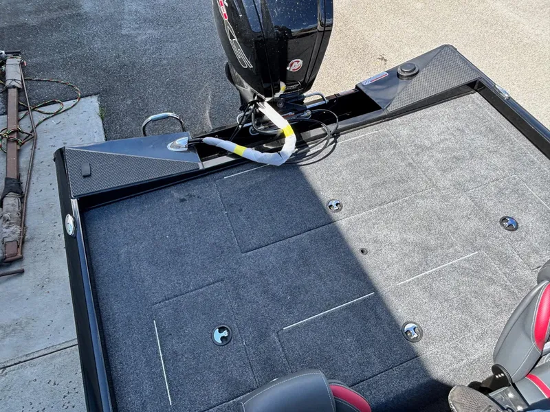 Slide: The Image of 2025 Ranger RT188 boat deck with motor, featuring a spacious, carpeted surface. - 8