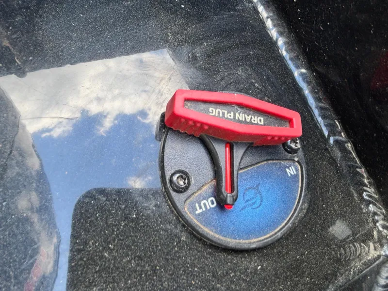 Slide: The Image of 2025 Ranger RT188 drain plug with red handle on black surface. - 9