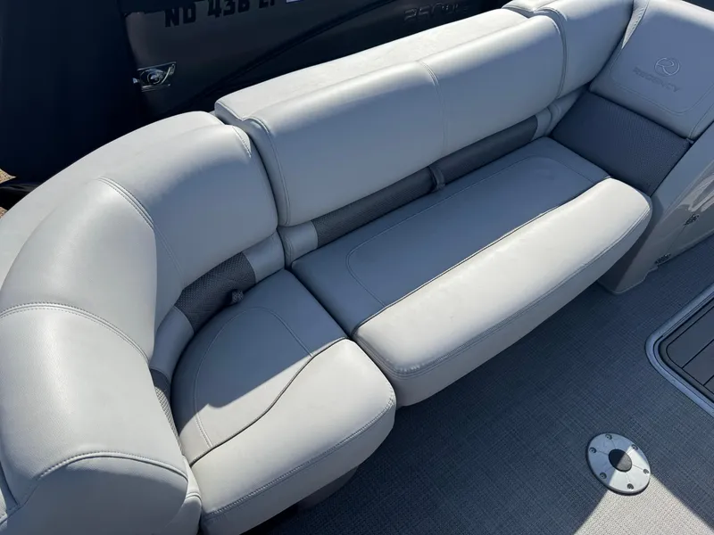 Slide: The Image of Luxurious seating on 2020 Regency 230 LE3 boat, featuring plush gray upholstery. - 18
