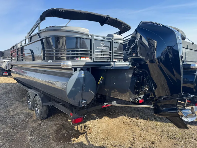Slide: The Image of 2020 Regency 230 LE3 pontoon boat in a warehouse setting. - 2