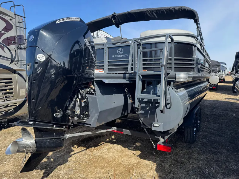 Slide: The Image of 2020 Regency 230 LE3 pontoon boat with Mercury outboard motor in a warehouse setting. - 4