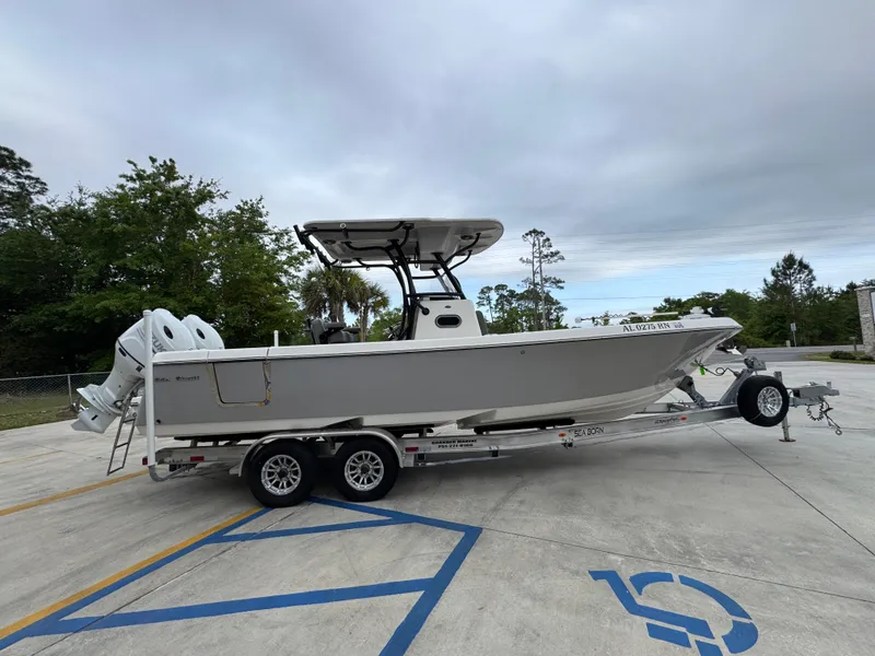 Slide: The Image of 2023 Sea Born LX26 Center Console boat on trailer in parking lot. - 10