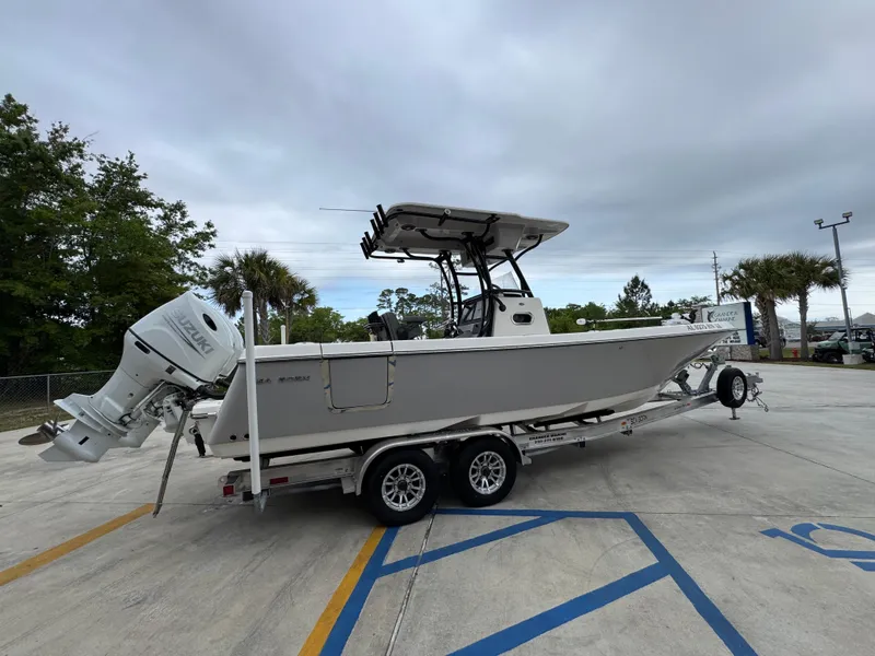 Slide: The Image of 2023 Sea Born LX26 Center Console boat on trailer, parked outdoors. - 11