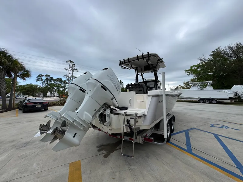 Slide: The Image of 2023 Sea Born LX26 Center Console boat with dual outboard motors on a trailer. - 13
