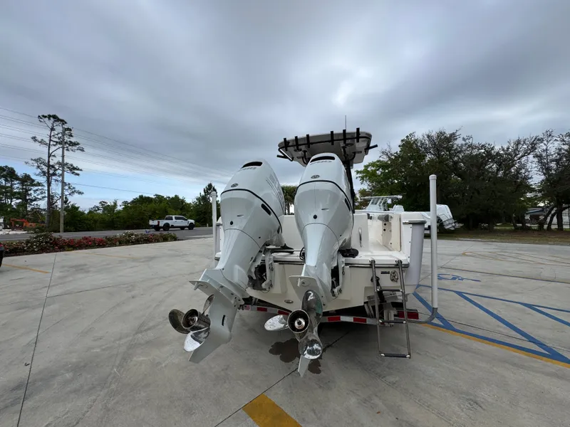 Slide: The Image of 2023 Sea Born LX26 Center Console boat with dual outboard motors on a trailer. - 14