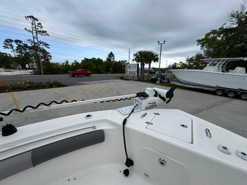 Slide: The Image of 2023 Sea Born LX26 Center Console boat at a dealership, featuring a trolling motor. - 20