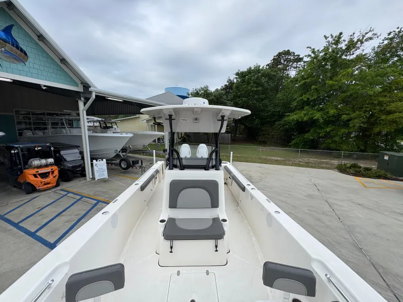 Slide: The Image of 2023 Sea Born LX26 Center Console boat at a marina, showcasing spacious deck and seating. - 22
