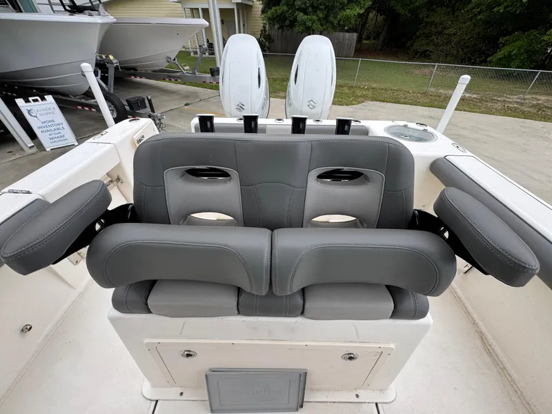Slide: The Image of 2023 Sea Born LX26 Center Console boat with gray cushioned seating and dual motors. - 26