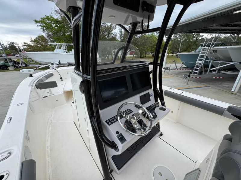 Slide: The Image of 2023 Sea Born LX26 Center Console boat with modern helm and dual displays. - 27