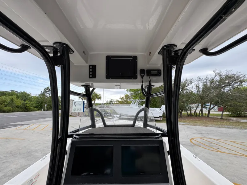 Slide: The Image of 2023 Sea Born LX26 Center Console boat interior with dual screens and overhead electronics. - 29