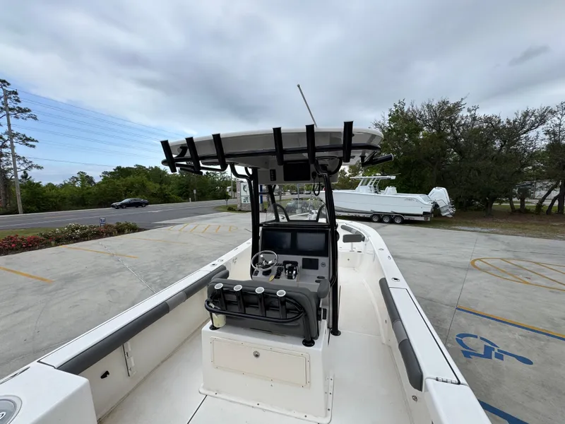 Slide: The Image of 2023 Sea Born LX26 Center Console boat with T-top in parking lot. - 35