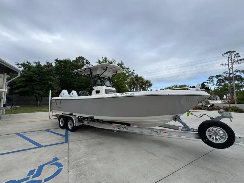 Slide: The Image of 2023 Sea Born LX26 Center Console boat on trailer, parked outdoors. - 8