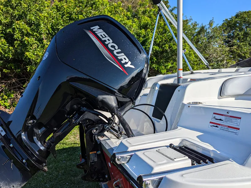 Slide: The Image of 2025 Bayliner Element M17 with Mercury outboard motor, parked on grass. - 14