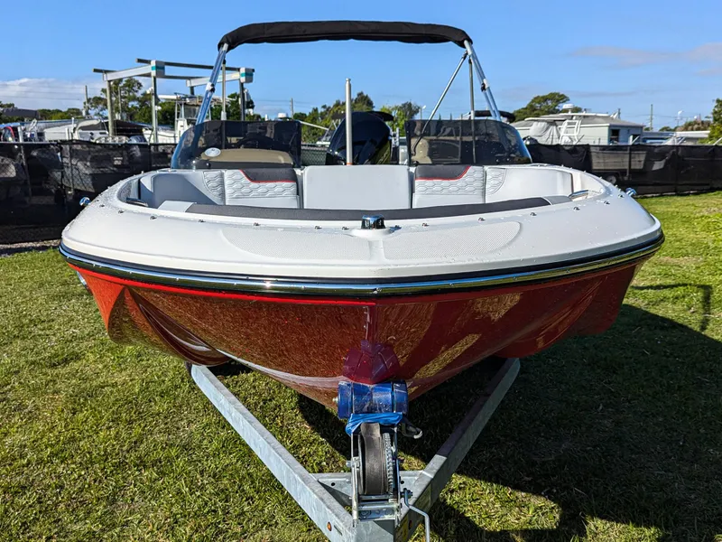 Slide: The Image of 2025 Bayliner Element M17 boat on trailer, displayed outdoors on grass. - 5