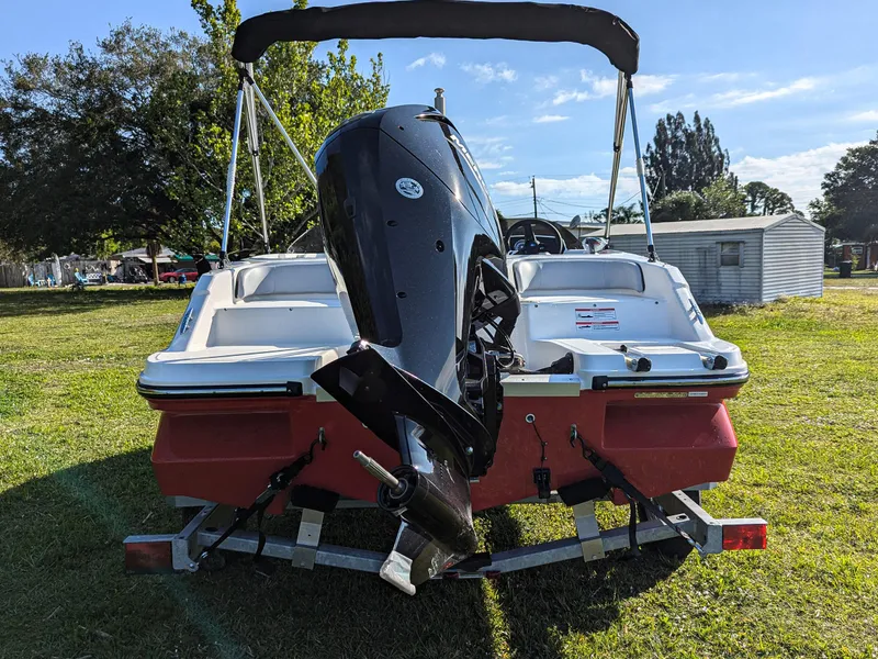 Slide: The Image of 2025 Bayliner Element M17 boat on trailer, rear view, parked on grass. - 7