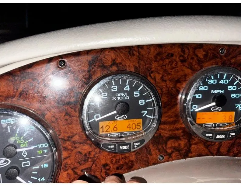 Slide: The Image of Dashboard of 2006 Sea Ray 280 Sundancer showing RPM, voltage, and speed gauges. - 12