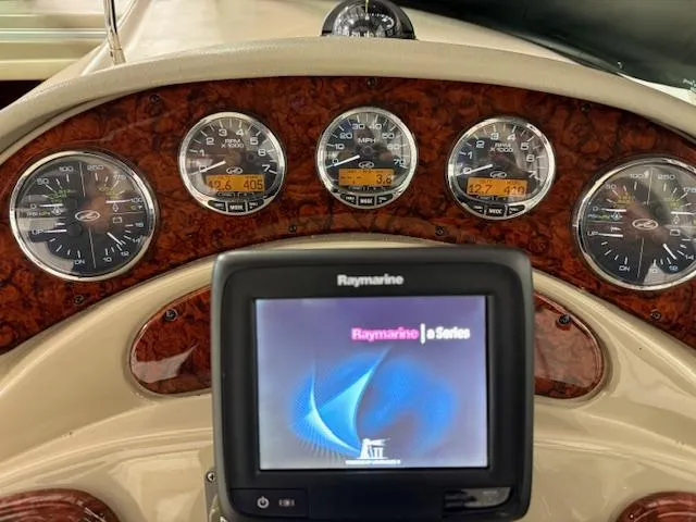 Slide: The Image of Dashboard of 2006 Sea Ray 280 Sundancer with Raymarine display and gauges. - 15
