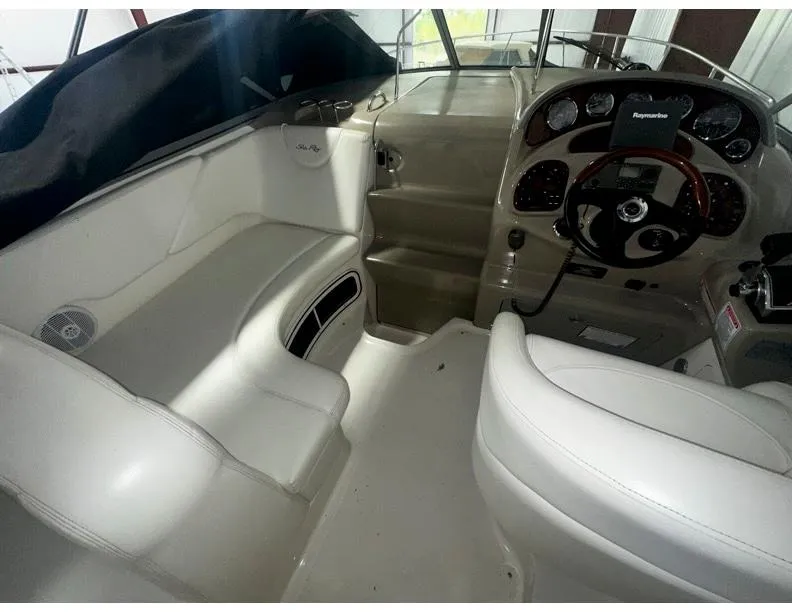 Slide: The Image of 2006 Sea Ray 280 Sundancer cockpit with steering wheel and seating area. - 3