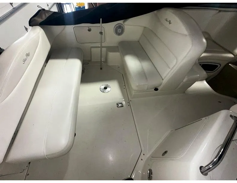 Slide: The Image of 2006 Sea Ray 280 Sundancer interior with white seating and sleek design. - 4