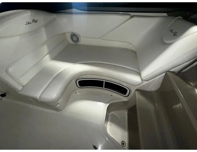 Slide: The Image of 2006 Sea Ray 280 Sundancer interior with white seating and speaker detail. - 5