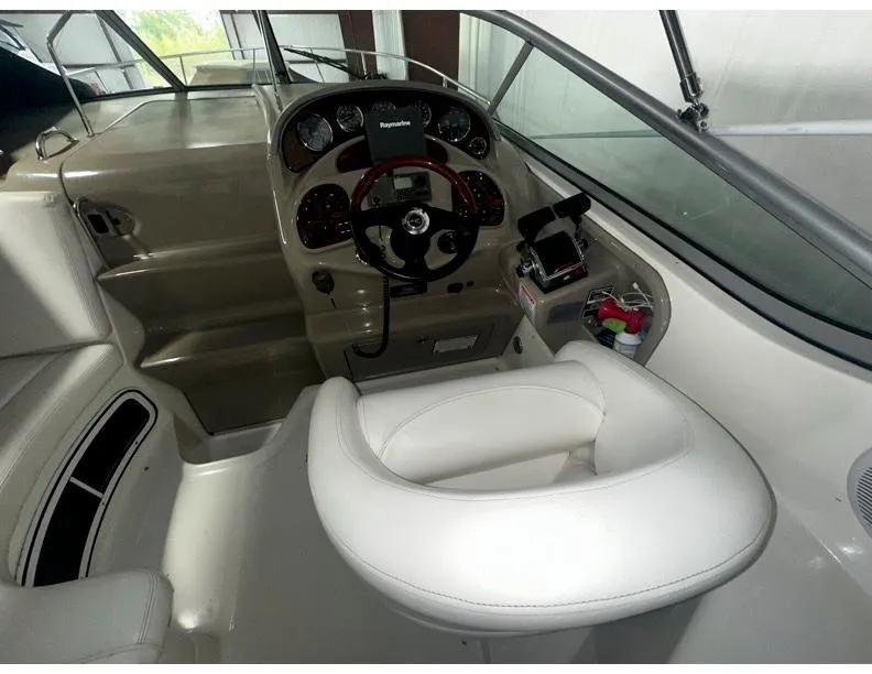 Slide: The Image of 2006 Sea Ray 280 Sundancer helm with steering wheel and control panel. - 6