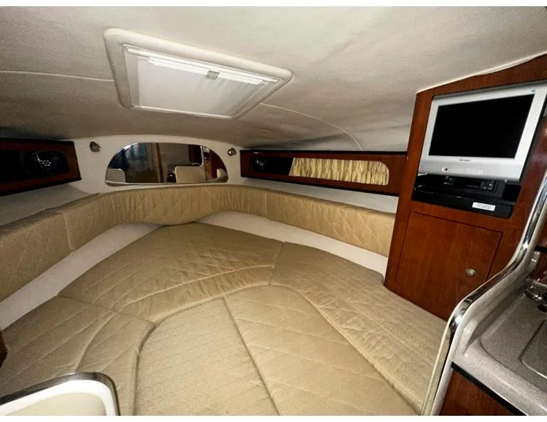 Slide: The Image of Interior of 2006 Sea Ray 280 Sundancer with beige seating and built-in TV. - 7
