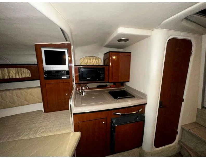 Slide: The Image of 2006 Sea Ray 280 Sundancer cabin interior with kitchenette and seating area. - 8