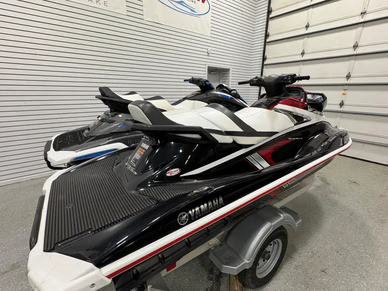 Slide: The Image of 2019 Yamaha WaveRunner FX Cruiser HO jet skis on trailer in garage. - 19