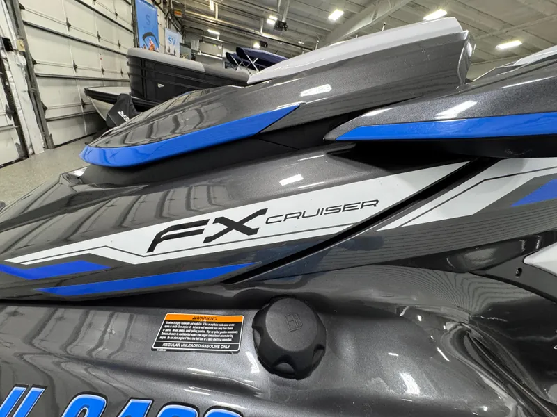 Slide: The Image of 2019 Yamaha WaveRunner FX Cruiser HO in a showroom, featuring sleek gray and blue design. - 24