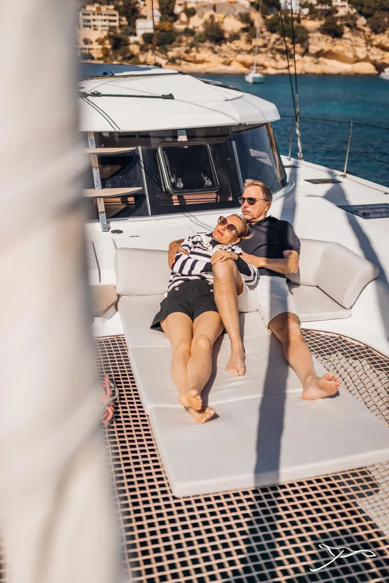 Slide: The Image of Couple relaxing on 2025 Nautitech 44 Open catamaran, enjoying sunny day at sea. - 11