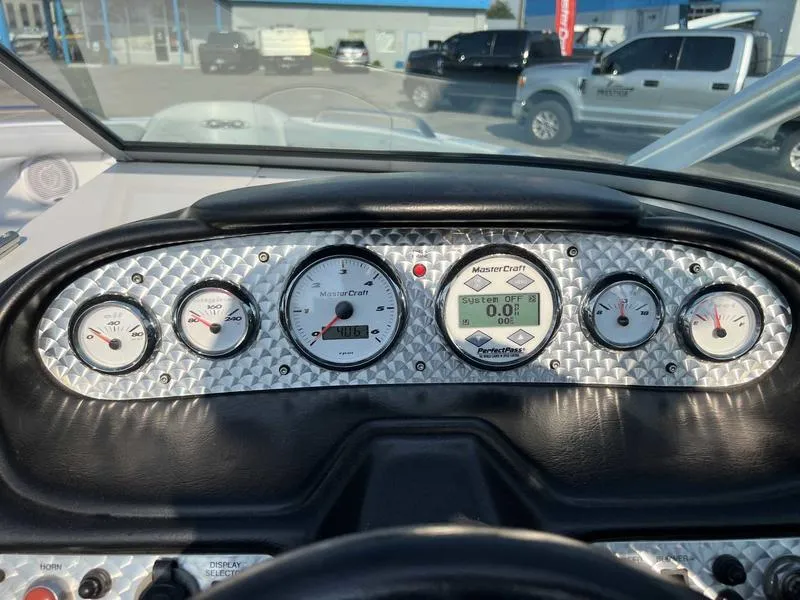 Slide: The Image of Dashboard of a 2004 MasterCraft X30 boat with gauges and digital display. - 1