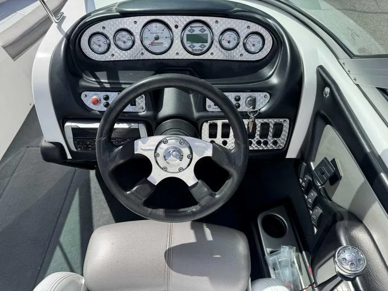 Slide: The Image of 2004 MasterCraft X30 boat dashboard with steering wheel and instrument panel. - 12