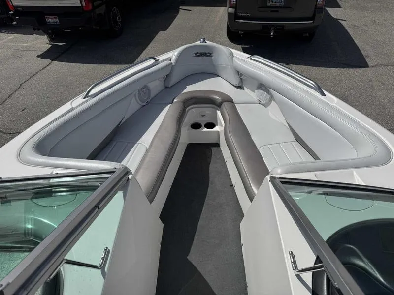Slide: The Image of 2004 MasterCraft X30 boat interior with gray seating and open bow design. - 13