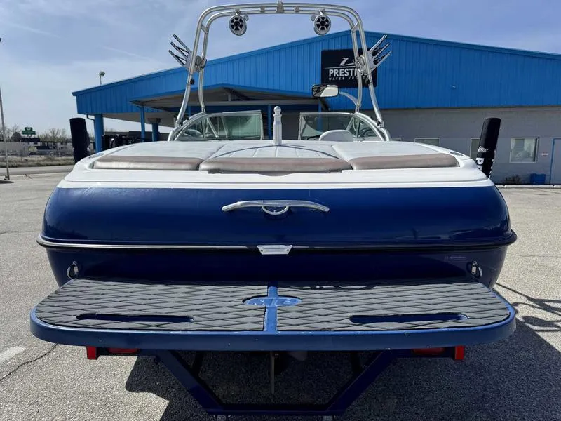 Slide: The Image of 2004 MasterCraft X30 boat, blue and white, rear view with wakeboard tower. - 6