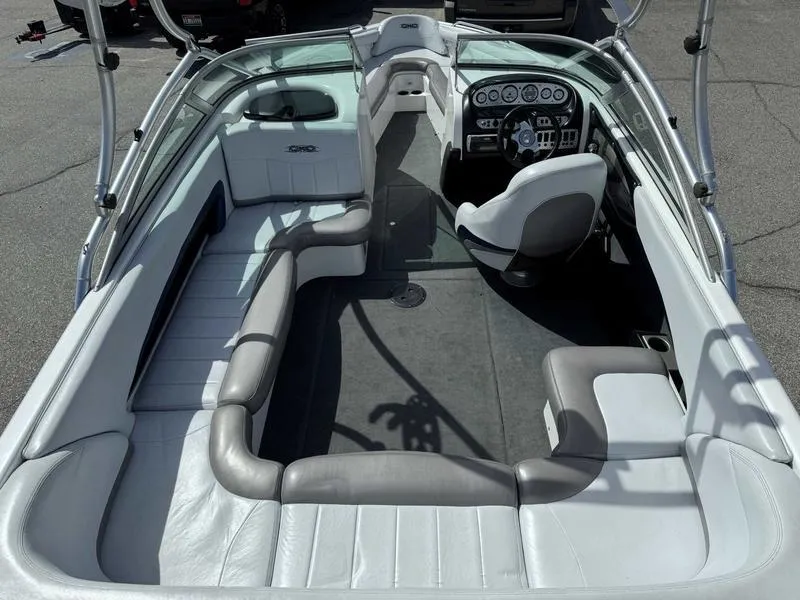 Slide: The Image of 2004 MasterCraft X30 boat interior with gray and white seating and dashboard. - 8