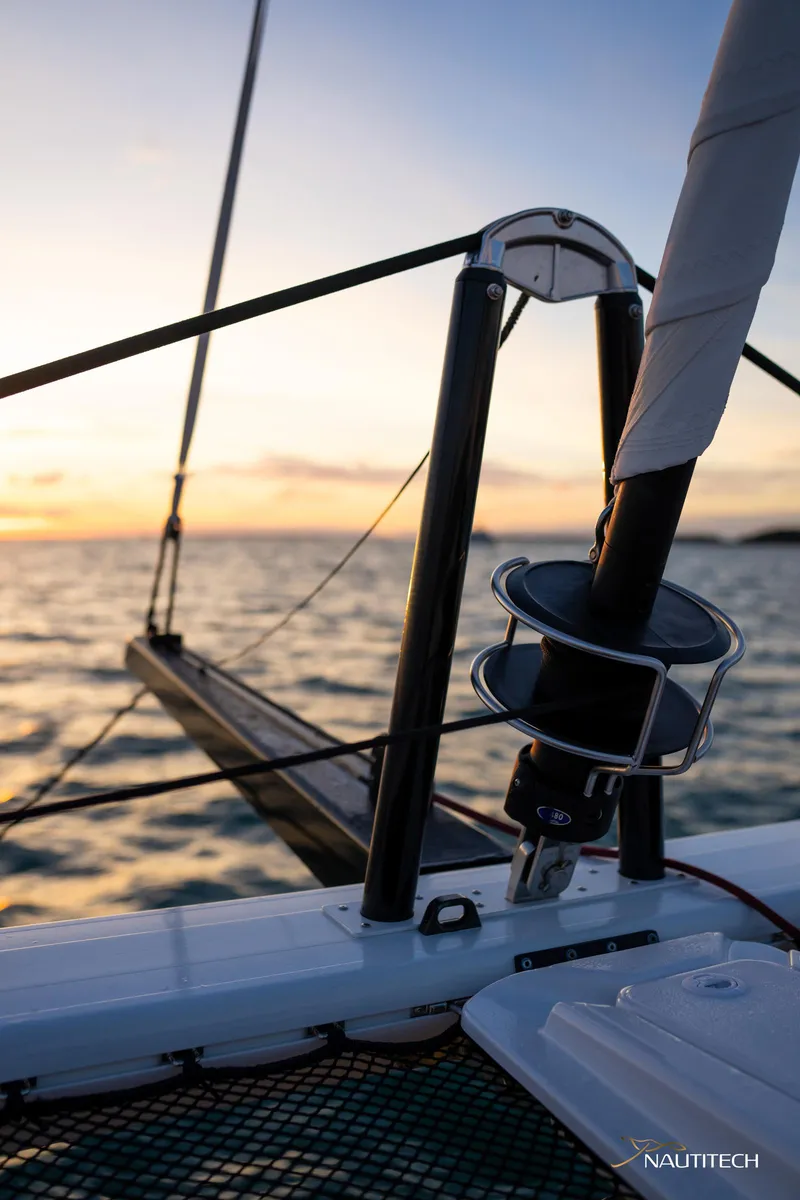 Slide: The Image of 2025 Nautitech 48 Open sailing at sunset, showcasing sleek design and advanced rigging. - 16