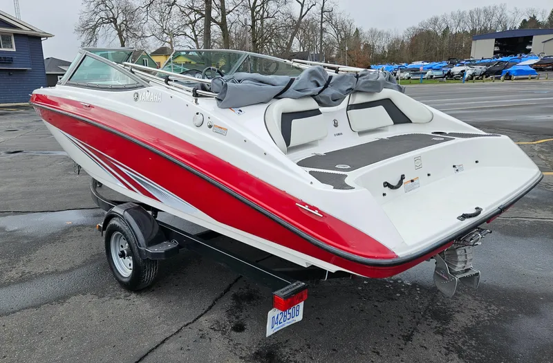 Slide: The Image of 2015 Yamaha Boats SX190, red and white, on trailer in parking lot. - 4