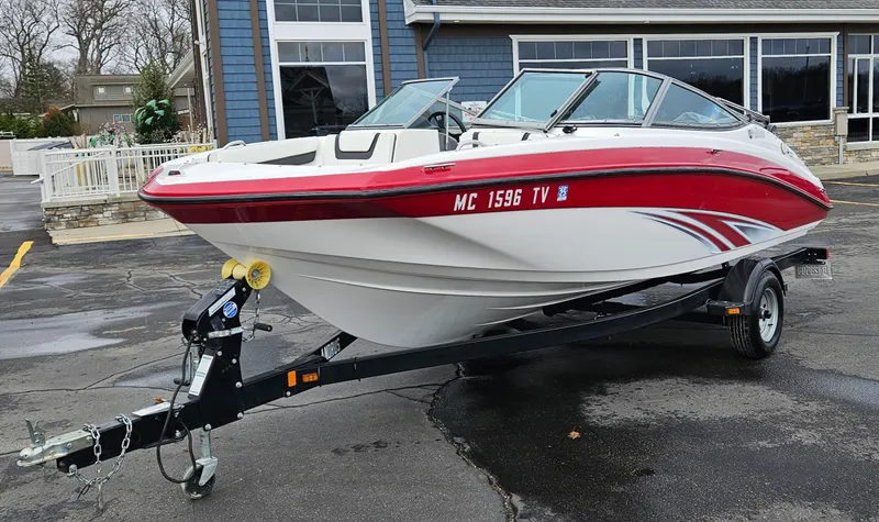 Slide: The Image of 2015 Yamaha SX190 boat on trailer, red and white design, parked outdoors. - 6
