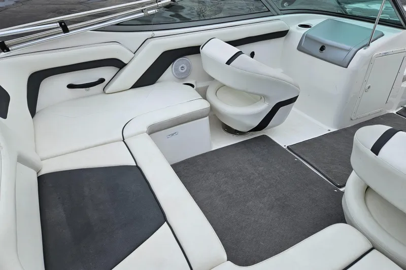 Slide: The Image of 2015 Yamaha Boats SX190 interior with white and black seating, modern design, and spacious layout. - 9