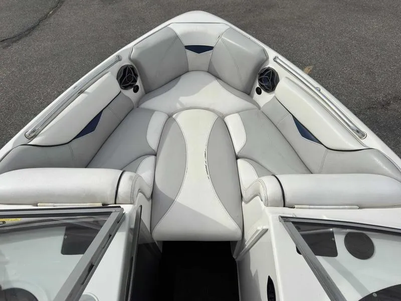 Slide: The Image of 2006 Tigé 22V boat interior with white and gray seating, featuring built-in speakers. - 11