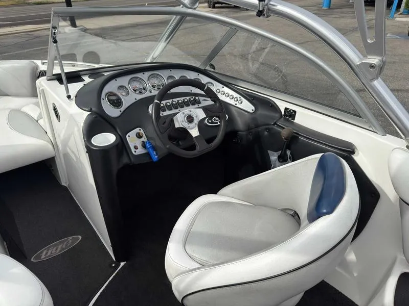 Slide: The Image of 2006 Tigé 22V boat interior with steering wheel and dashboard controls. - 14