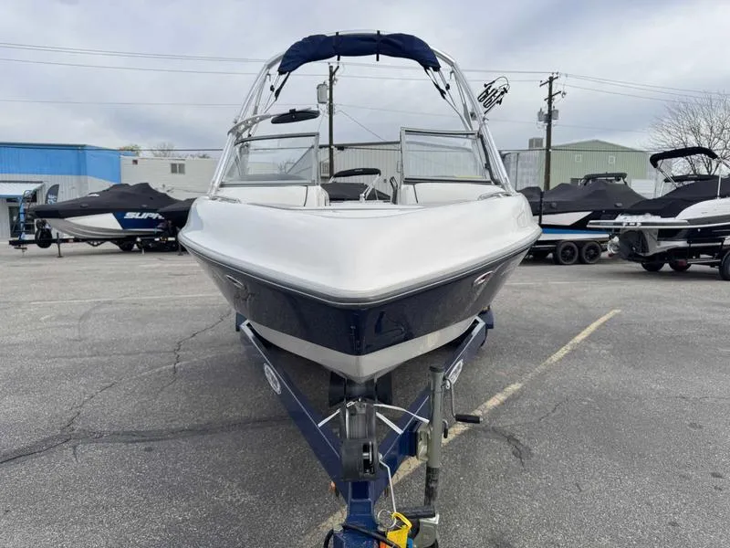 Slide: The Image of 2006 Tigé 22V boat on trailer in parking lot, front view. - 3