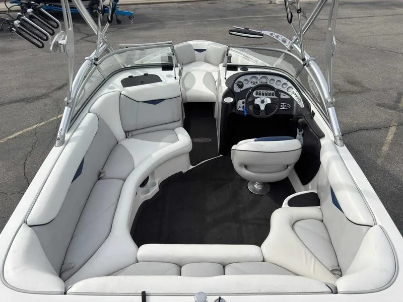 Slide: The Image of 2006 Tigé 22V boat interior with white seating and modern dashboard. - 7