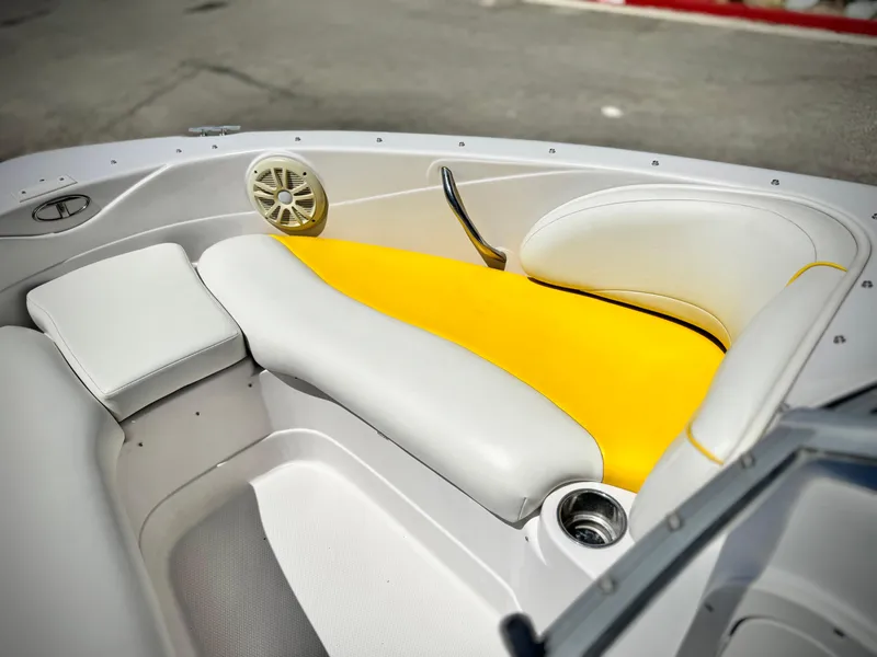 Slide: The Image of 2011 Tahoe Q8 SSi boat interior with yellow and white seating, speaker, and cup holder. - 11