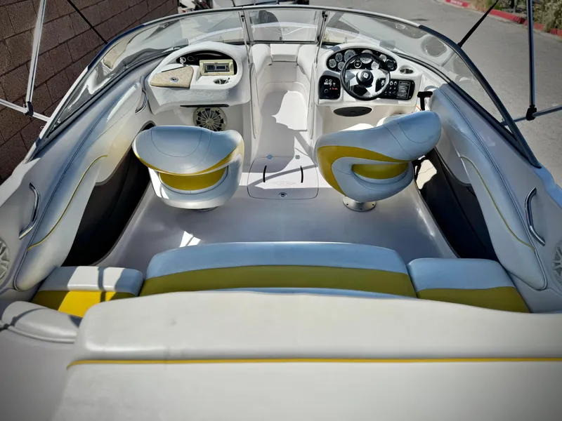Slide: The Image of 2011 Tahoe Q8 SSi boat interior with white and yellow seating, steering console, and dashboard. - 12