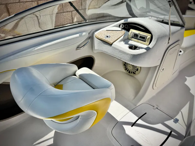 Slide: The Image of 2011 Tahoe Q8 SSi boat interior with steering console and cushioned seat. - 17