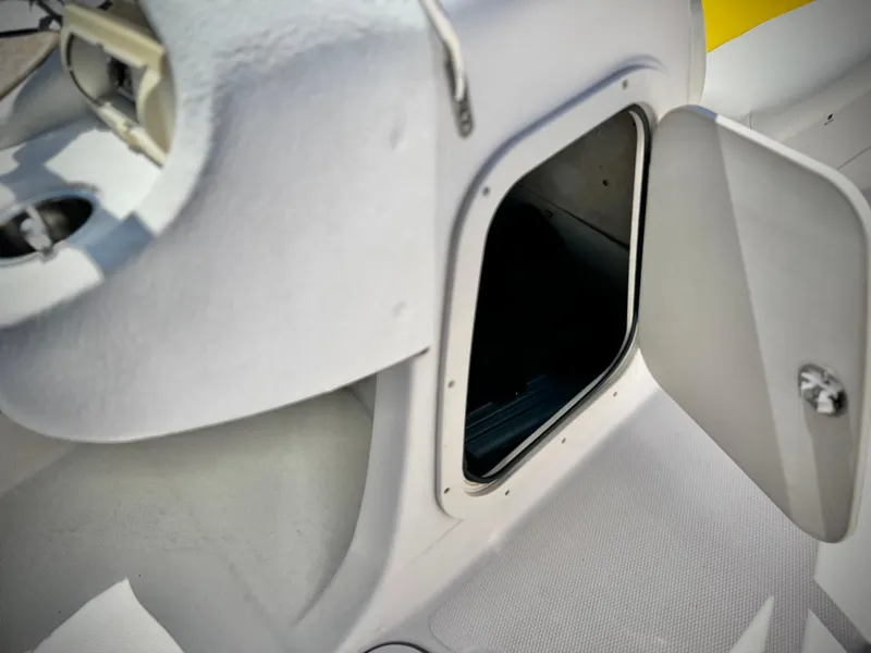 Slide: The Image of Open storage compartment on a 2011 Tahoe Q8 SSi boat. - 19
