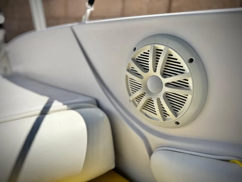 Slide: The Image of Speaker on 2011 Tahoe Q8 SSi boat interior, featuring white upholstery and sleek design. - 21