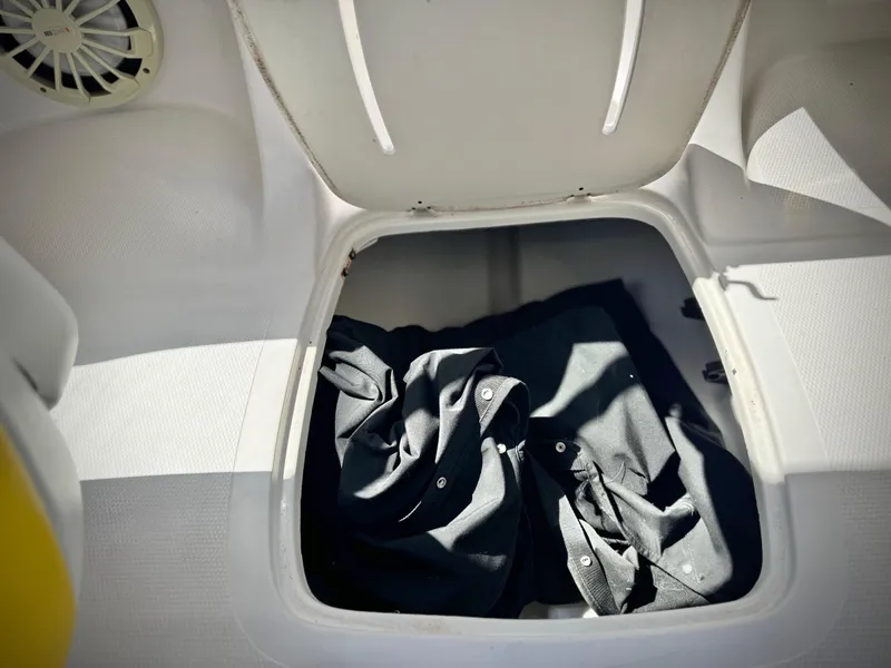 Slide: The Image of Storage compartment in a 2011 Tahoe Q8 SSi boat with black fabric inside. - 22