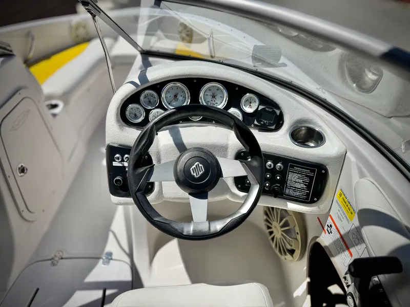 Slide: The Image of Steering console of a 2011 Tahoe Q8 SSi boat with gauges and controls. - 24
